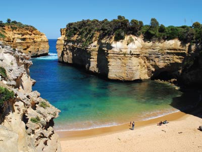 Loch Ard Gorge with sandy beach, sheer cliffs rising from ocean on Great Ocean Road tours