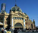 Flinders Street Station in the heart of Melbourne with Eureka tower behind it in background